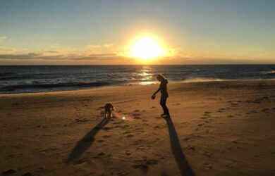 Virginia Beach Sunrise with a silhouette of Mary Stone and her golden retriever Miss Ellie Mae.