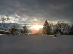 a sunset in a winter snow at the Karen Ann Quinlan Home for Hospice