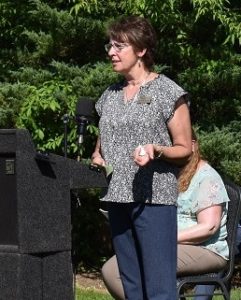 a woman speaking behind a podium