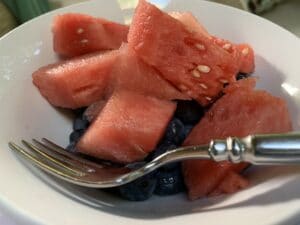 white bowl with watermelon cubes and blueberries