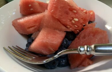 white bowl with watermelon cubes and blueberries