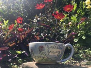 ceramic mug on rock in garden