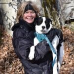 columnist Mary Stone holding her new puppy rescue. A mixed breed white with back spots and patches of fur