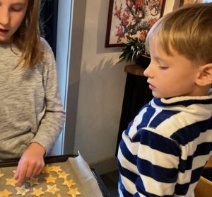 a girl and boy baking star shaped dog treats