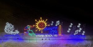 Holiday Lights at night in front of a beach with the saying Living the Life, Virginia Beach, VA. 