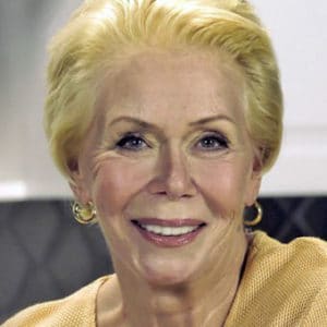 a portrait of beautiful older woman =, Louise Hay, with short blond hair and big smile.