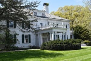 a large white Victorian home and main house at the Frelinghuysen Arboretum