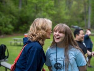 Campers and volunteers participating in an outdoor team-building activity at Comfort Zone Camp.