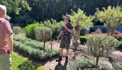 Patrick McDuffee leading a tour through the formal herb garden at Well-Sweep Herb Farm.