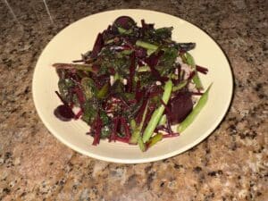 Simple stir fry made with homegrown beet greens, green beans, beets, and garlic.
